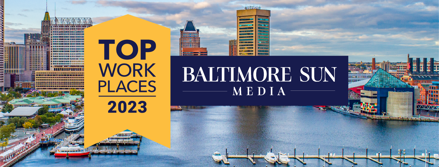 Top Workplaces of Baltimore 2023 emblem over a skyline picture of the Baltimore inner harbor