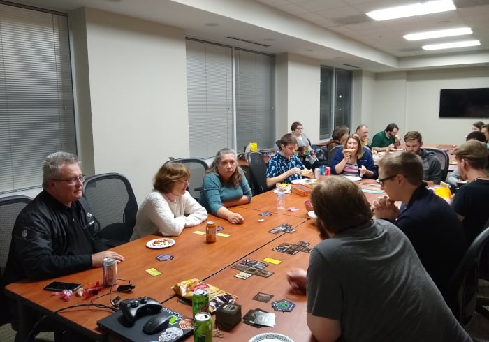 Interclypse employees gathered around a conference table playing board games