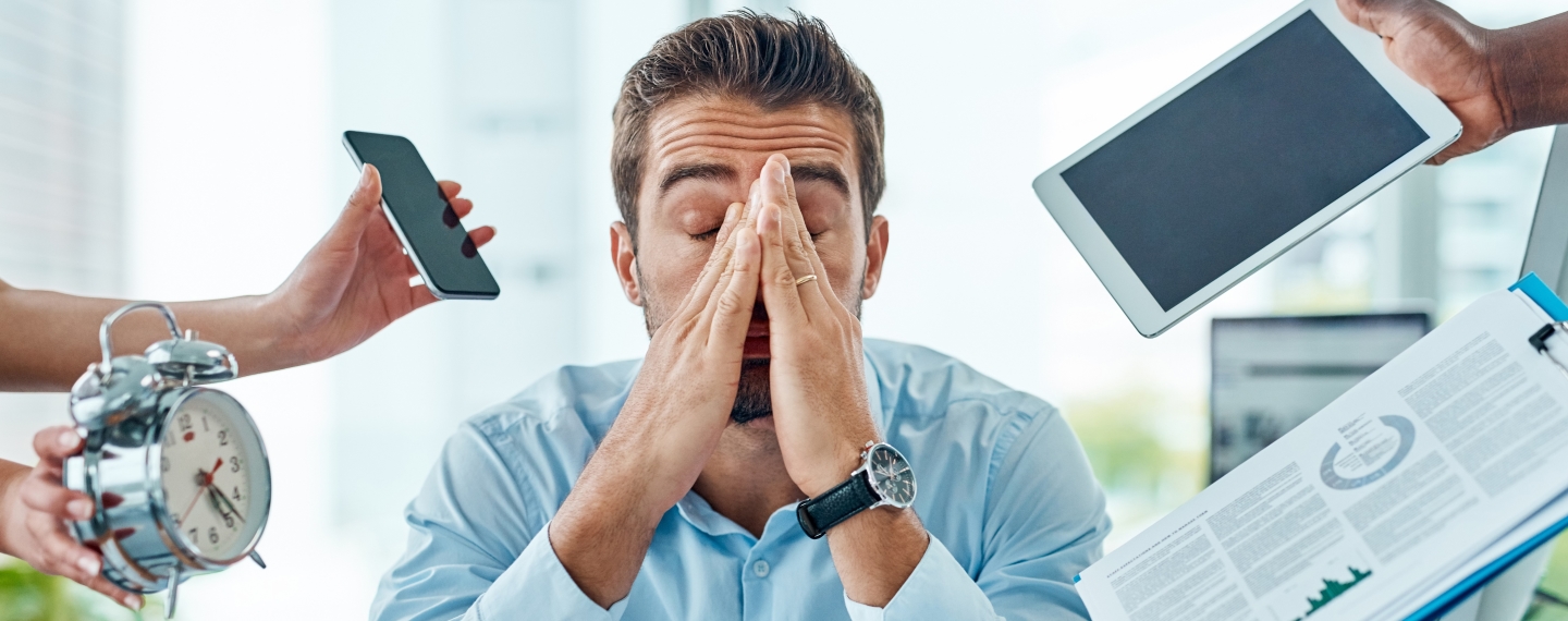 a man overwhelmed by people offering him technological devices that represent requirements and needs